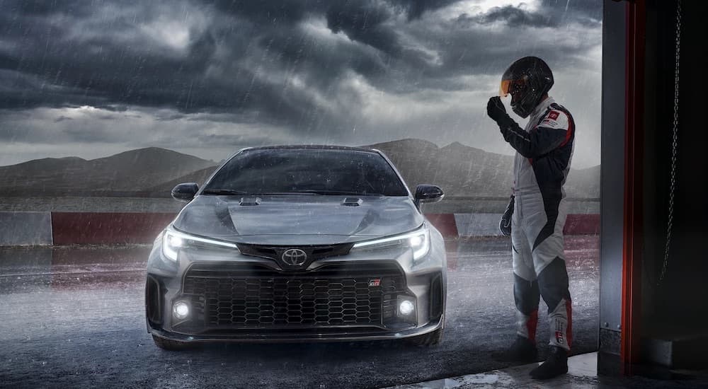 A grey 2023 Toyota GR Corolla is shown from the front in the pits in the rain after leaving a Toyota Dealer.