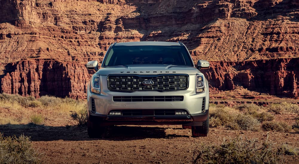 A silver 2021 Kia Telluride is shown from the front parked near mountains.
