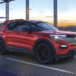 A red 2022 Ford Explorer ST-Line is shown driving over a bridge.