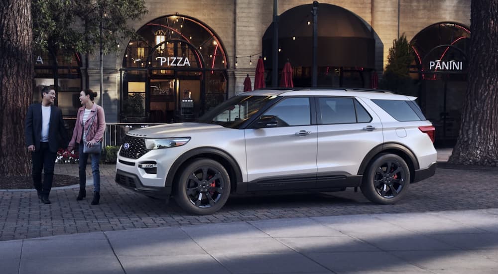 A white 2022 Ford Explorer ST-Line is shown parked in front of a store.