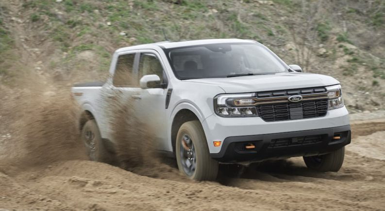 A grey 2022 Ford Maverick Tremor is shown from the front at an angle while driving off-road.