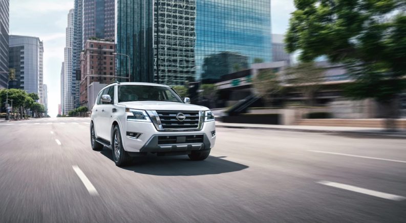 A white 2022 Nissan Armada is shown from the front at an angle on a city street.