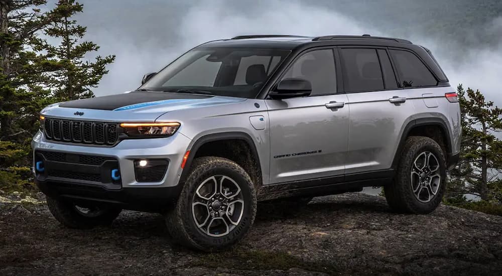 A grey 2022 Jeep Grand Cherokee 4xe is shown parked in the mountains.
