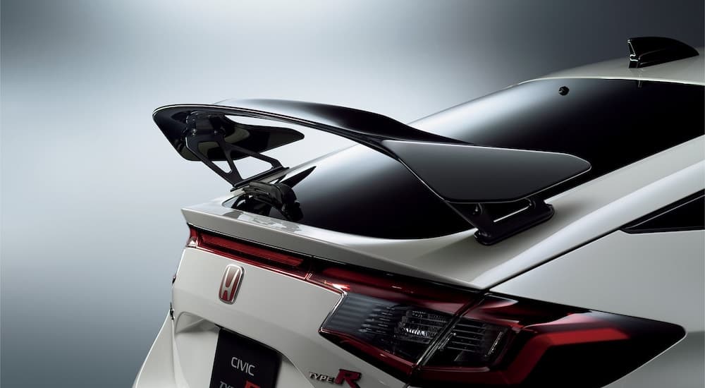 A close-up of the rear spoiler of a white 2023 Honda Civic Type R is shown.