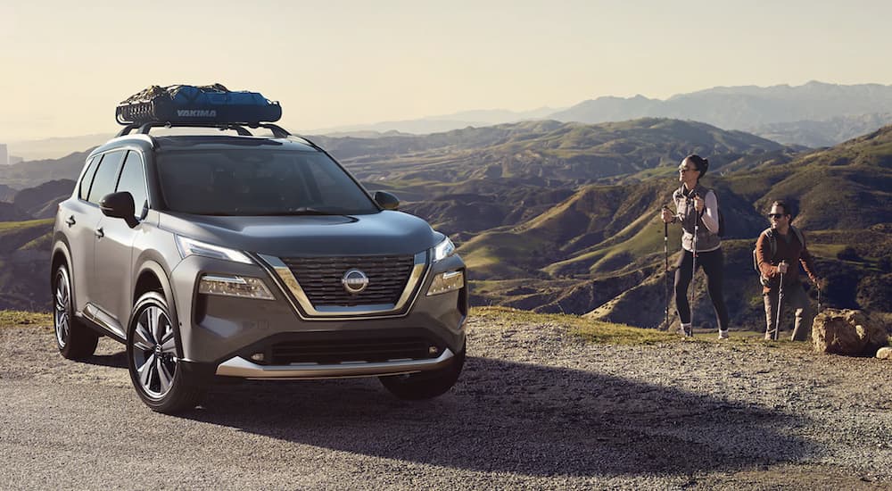 A grey 2023 Nissan Rogue is shown parked in front of a mountain range after leaving a Nissan Rogue dealership.