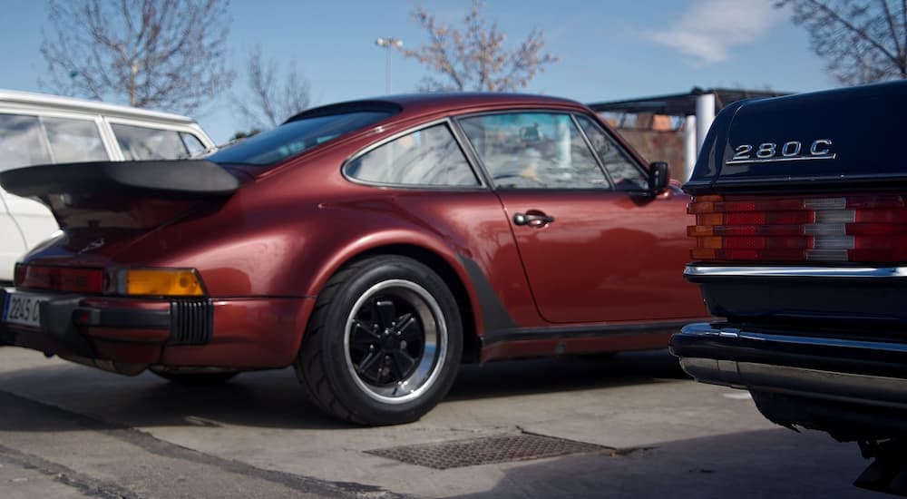 A maroon classic Porsche 911 is shown from behind.