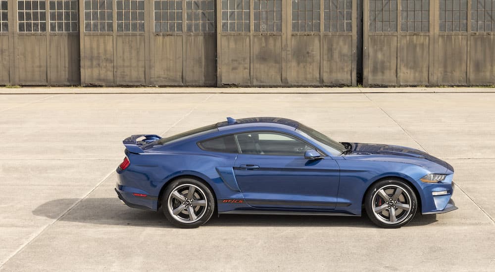 A blue 2022 Ford Mustang GT C/S is shown from the side while parked on a runway.