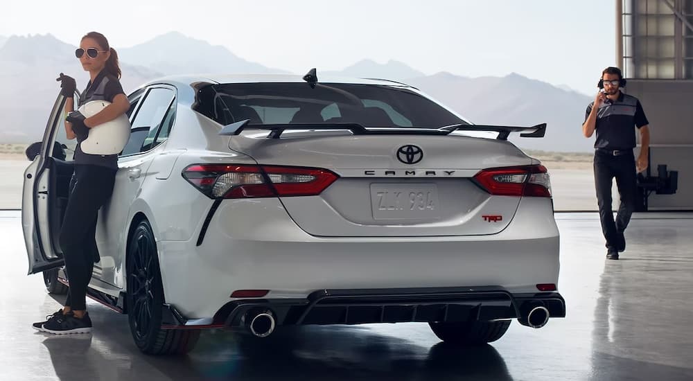 A white 2023 Toyota Camry TRD is shown from the rear at an angle.