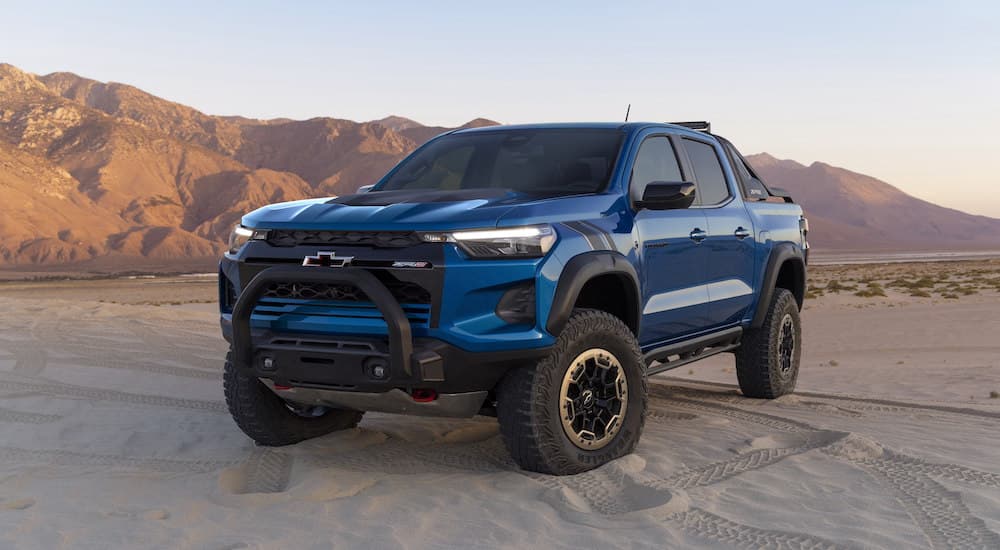 A blue 2023 Chevy Colorado ZR2 is shown from the front at an angle while parked off-road.