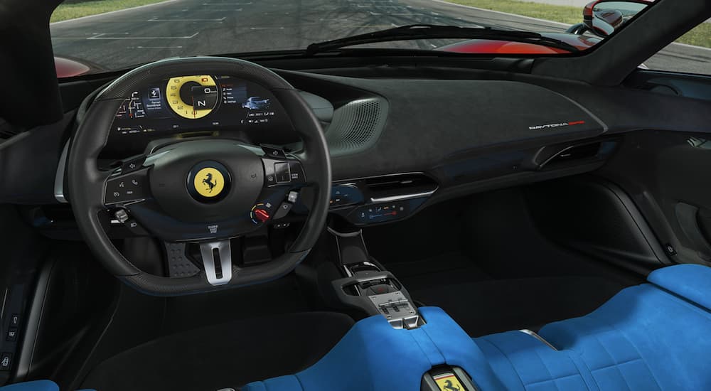 The black interior of a 2023 Ferrari Daytona SP3 shows the steering wheel.
