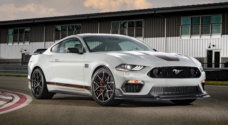 A grey 2022 Ford Mustang Mach 1 is shown from the front at an angle on a racetrack.