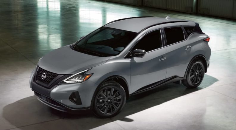 A grey 2022 Nissan Murano for sale is shown parked in a garage.