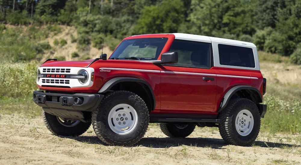 A red 2023 Ford Bronco Heritage Edition is shown parked off-road.