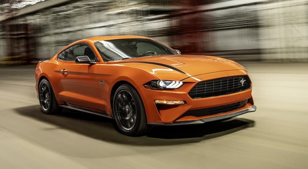 An orange 2021 Mustang Ecoboost HPP is shown from the front at an angle.
