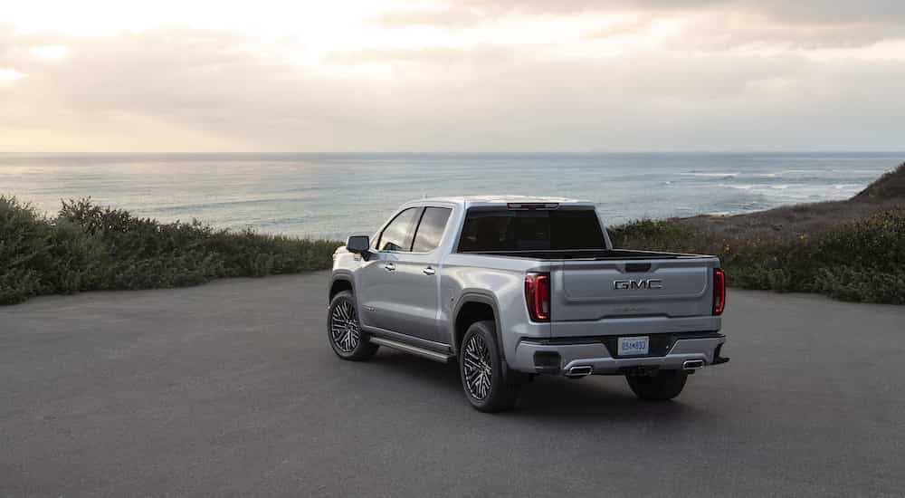 A silver 2022 GMC Sierra 1500 Denali Ultimate is shown from the rear at an angle after leaving a GMC Sierra 1500 dealer.