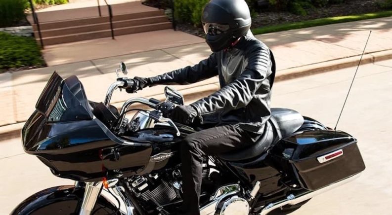 A black 2022 Harley Davidson Road Glide is shown from the side at a high angle.