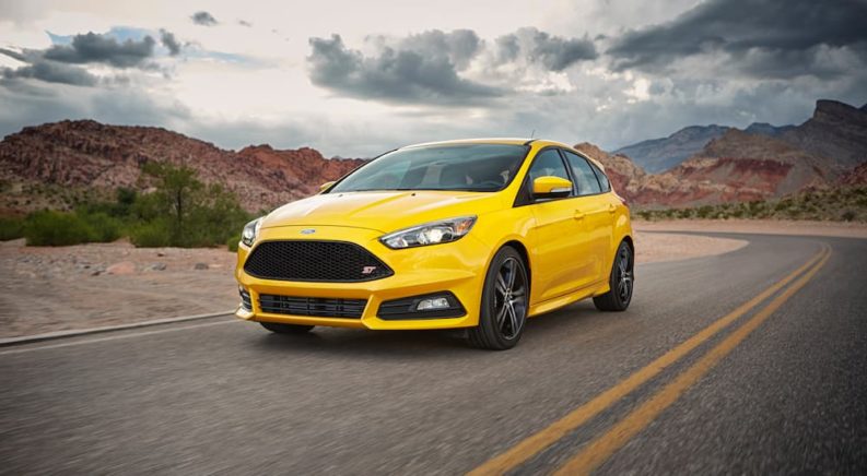 A yellow 2017 Ford Focus ST is shown from the front at an angle.