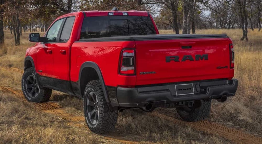 A red 2022 Ram 1500 Rebel is shown from the rear at an angle after leaving a dealer that had a Ram 1500 for sale.