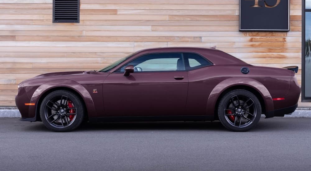 A purple 2021 Dodge Challenger Scat Pack Widebody is shown from the side after leaving a used Dodge dealer.