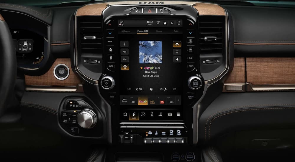 The black interior of a 2023 Ram 1500 shows the infotainment screen.