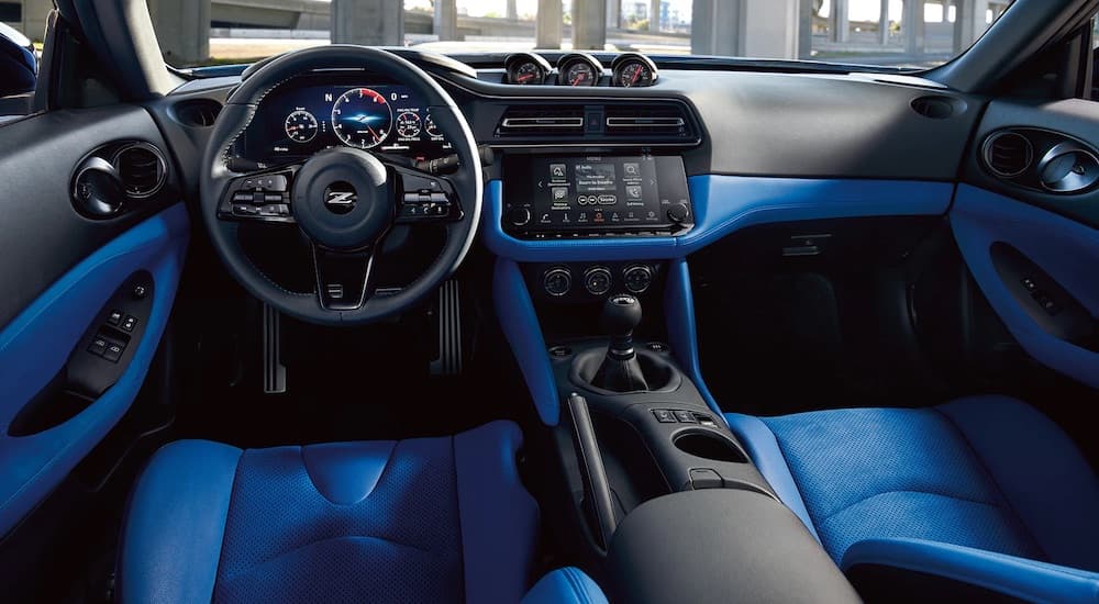 The blue interior of a 2023 Nissan Z is shown from the drivers seat.
