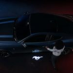 A black 2024 Ford Mustang is shown from above.