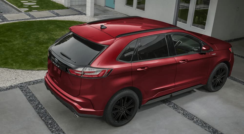A red 2023 Ford Edge is shown parked in a driveway.