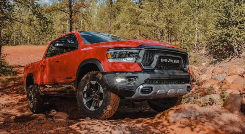 A red 2022 Ram 1500 is shown from the front while off-road after leaving a Ram 1500 dealer.