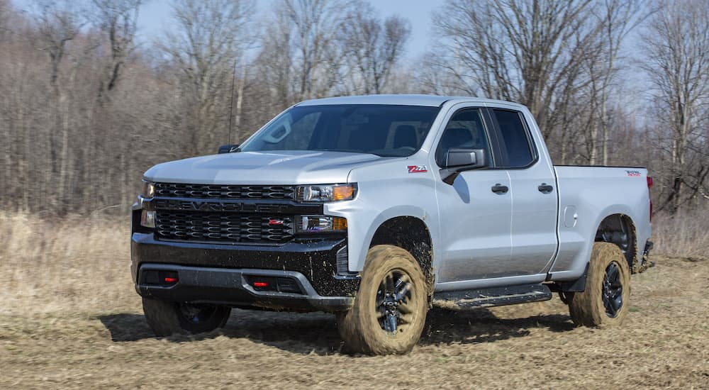 A grey 2023 Chevy Silverado Custom Z71 Trail Boss is shown from the front at an angle after leaving a dealer that sold a Chevy Silverado 1500 near me.