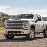 A silver 2023 Chevy Silverado 2500 HD is shown from the front at an angle.