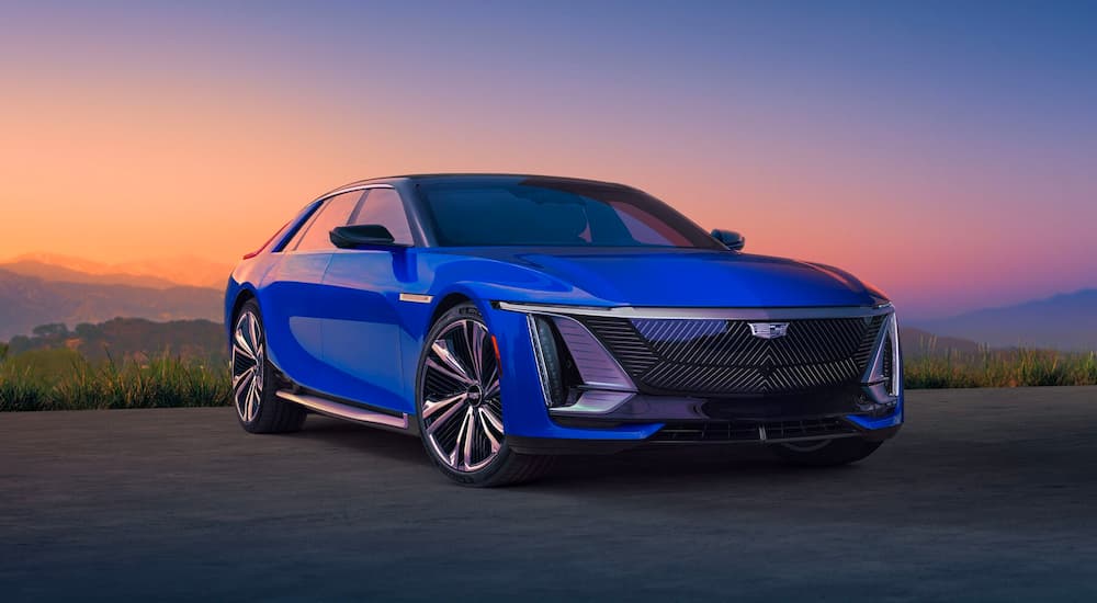 A blue 2024 Cadillac Celestiq is shown from a front angle are sunset.