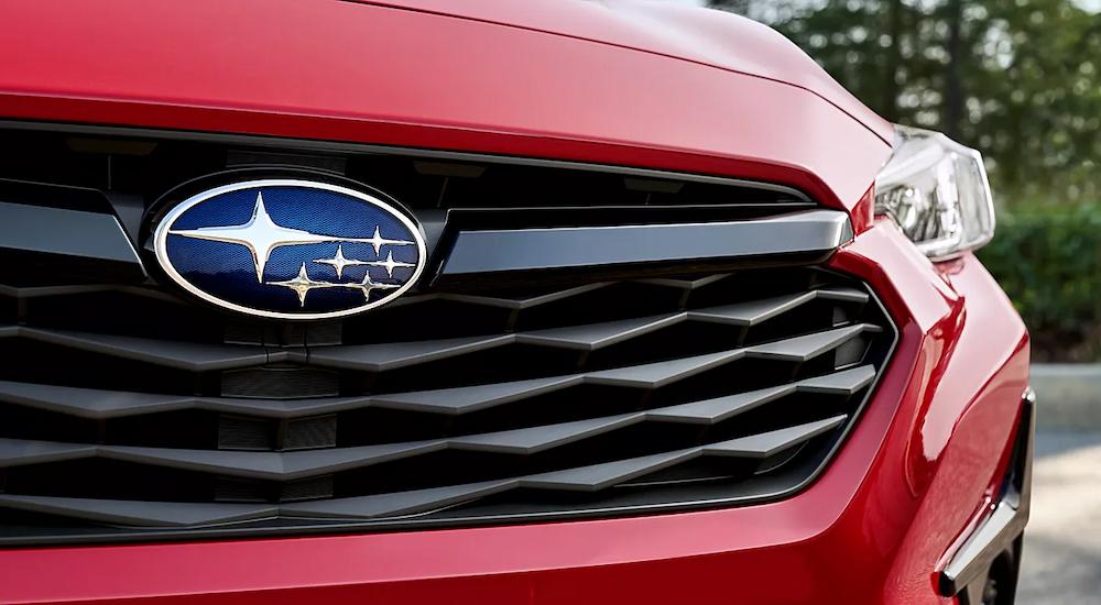 A close up of the grille on a red 2024 Subaru Impreza is shown.