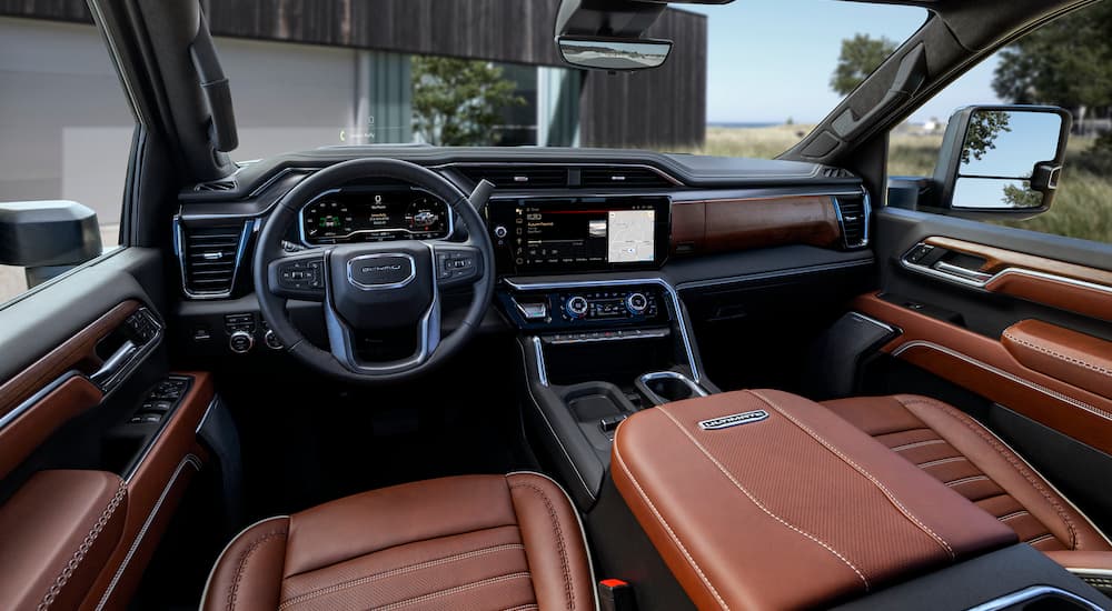 The brown interior of a 2024 GMC Sierra Denali Ultimate is shown from the drivers seat.
