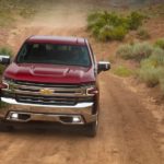 A maroon 2019 Chevy Silverado 1500 LTZ is shown on a trail after leaving a Chevrolet dealer.