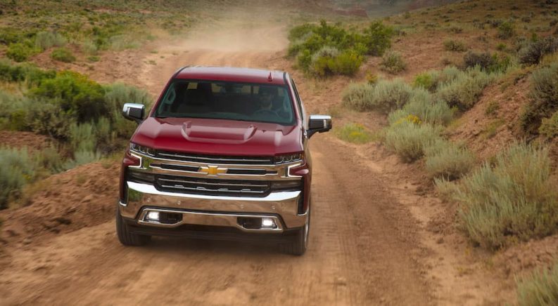 A maroon 2019 Chevy Silverado 1500 LTZ is shown on a trail after leaving a Chevrolet dealer.