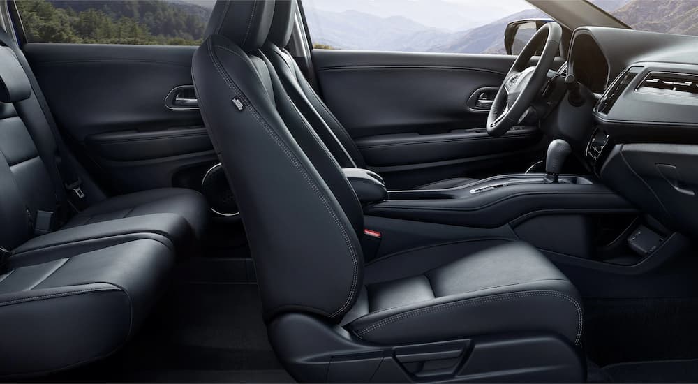 The black interior of a 2022 Honda HR-V EX shows the two rows of seating at a Honda dealer.