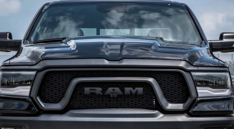 A close up of the front of a blue 2023 Ram 1500 Rebel is shown.