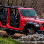 A red 2023 Jeep Wrangler Rubicon 4xe is shown from the side.