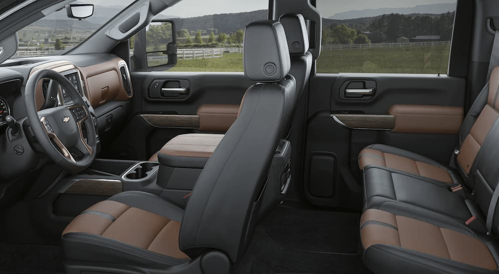The black and brown interior of a 2023 Chevy Silverado 3500 HD shows two rows of seating.