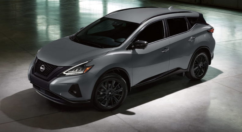 A grey 2023 Nissan Murano is shown from the side in a gallery.