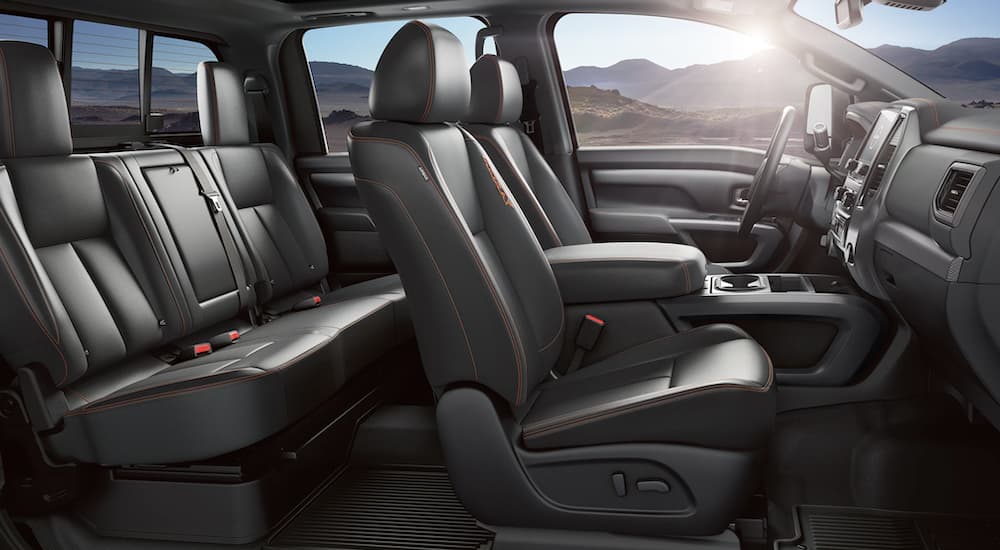 The black interior of a 2023 Nissan Titan shows two rows of seating.