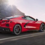 A red 2020 Chevy Corvette is shown on a mountain road after leaving a Chevrolet dealer.