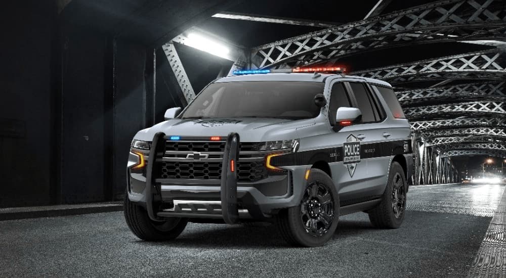 A grey 2021 Chevy Tahoe PPV is shown parked on a bridge.