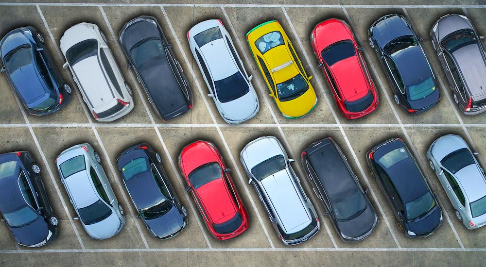 Two rows of used vehicles are shown from above.