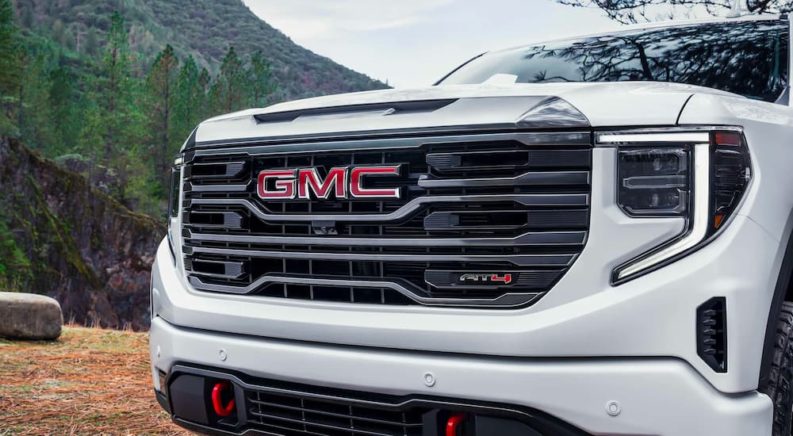 A close up shows the grille on a white 2023 GMC Sierra 1500 AT4.