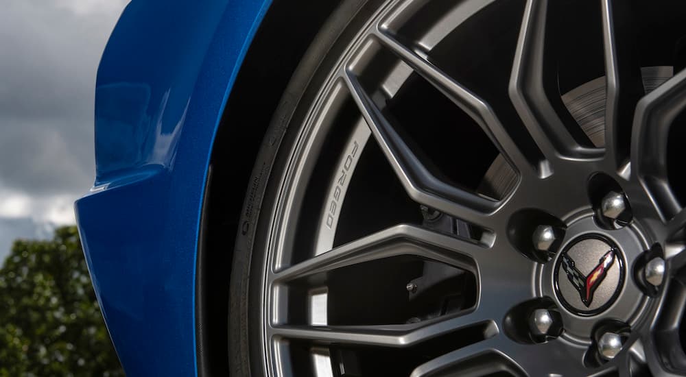 A close up shows the forged rim on a blue 2023 Chevy Corvette Stingray Z06.