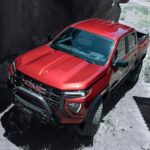 A red 2023 GMC Canyon AT4x is shown from the front at an angle.