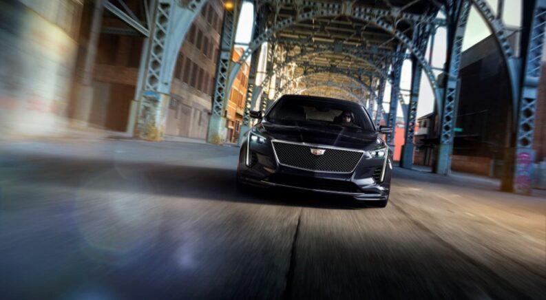 A black 2019 Cadillac CT6 V-Sport is shown driving through a tunnel after leaving a car dealer.