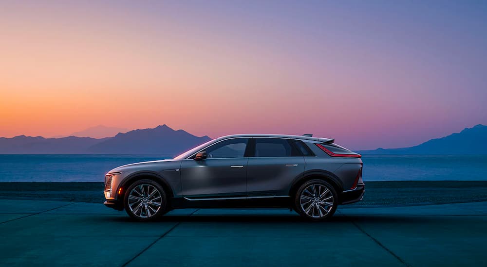 A silver 2023 Cadillac Lyriq is shown from the side at sunset.