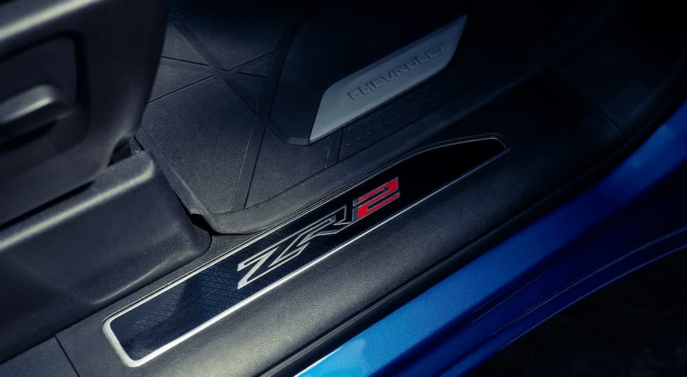 A close up of the floor mats and logo in a blue 2023 Chevy Silverado 1500 ZR2 is shown.